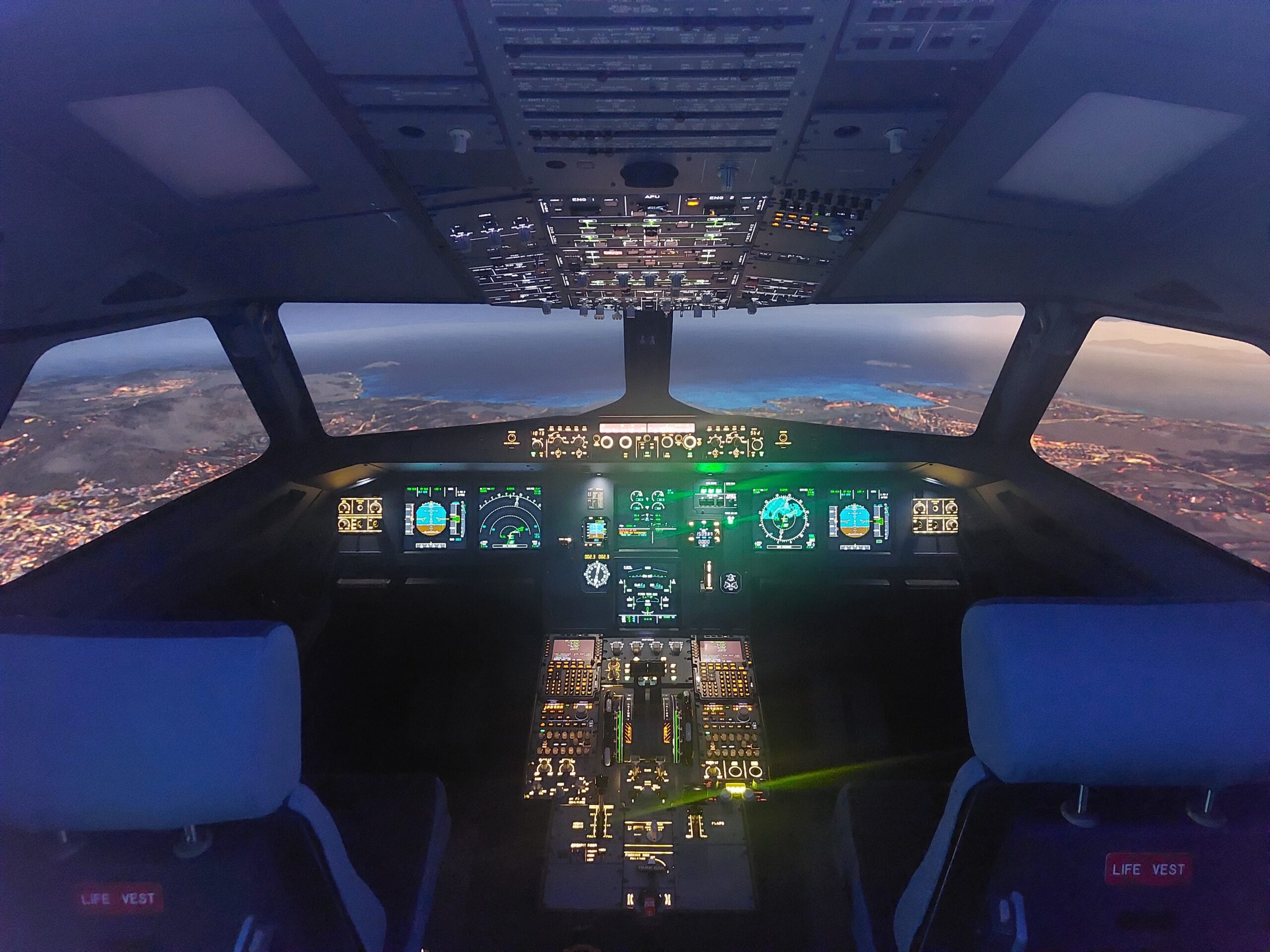 Airbus A320 simulator flight deck with a simulated landscape outside
